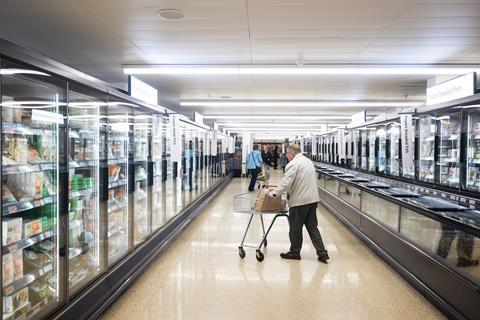 Shoppers pushing trolleys at Sainsbury’s Cobham store